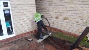 Work man draining water from hole