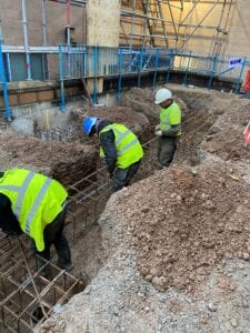 Work men putting steel supports into the ground