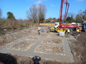 Cement being put into holes for piling